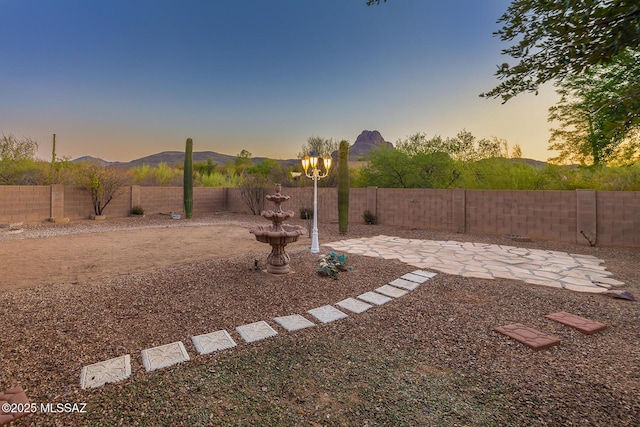8191 N White Stallion Pl, Tucson, AZ 85743 - yard at dusk with a patio and a fenced backyard