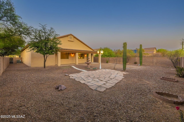 8191 N White Stallion Pl, Tucson, AZ 85743 - rear view of house with stucco siding, a fenced backyard, and a patio area