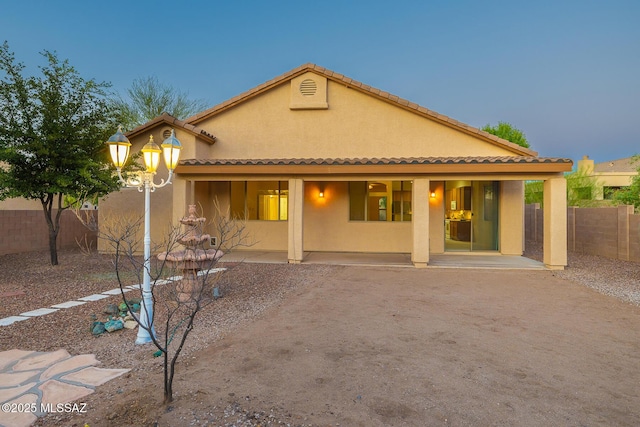 8191 N White Stallion Pl, Tucson, AZ 85743 - rear view of house with stucco siding, a tile roof, and a patio area