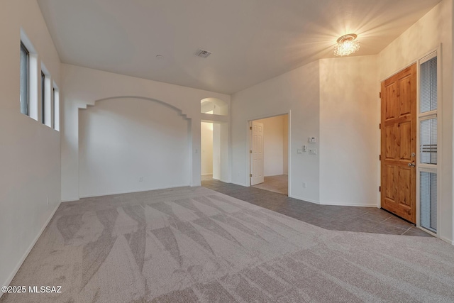 8191 N White Stallion Pl, Tucson, AZ 85743 - carpeted spare room featuring arched walkways and baseboards