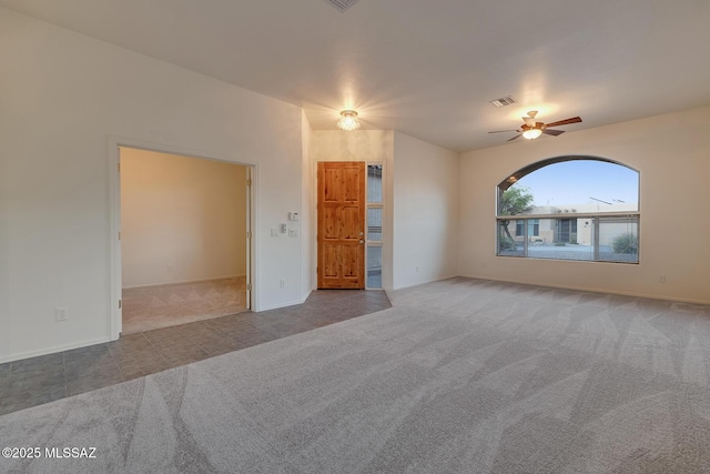 8191 N White Stallion Pl, Tucson, AZ 85743 - spare room featuring carpet flooring, a ceiling fan, and tile patterned flooring