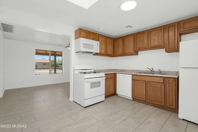 826 W Calle Margarita, Tucson, AZ 85706 - kitchen featuring white appliances, brown cabinets, light countertops, and a ceiling fan
