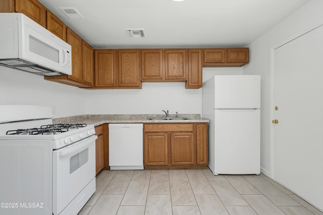 826 W Calle Margarita, Tucson, AZ 85706 - kitchen with white appliances, light countertops, and brown cabinetry