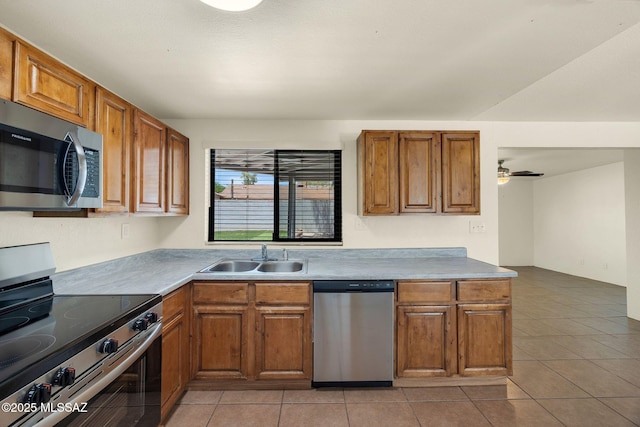 2520 W Vereda De Las Flores, Tucson, AZ 85746 - kitchen with stainless steel appliances, brown cabinetry, light tile patterned floors, and ceiling fan
