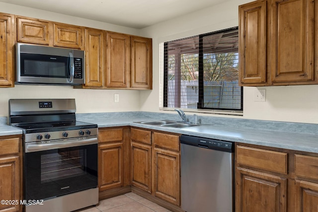 2520 W Vereda De Las Flores, Tucson, AZ 85746 - kitchen with appliances with stainless steel finishes, brown cabinets, and light tile patterned floors