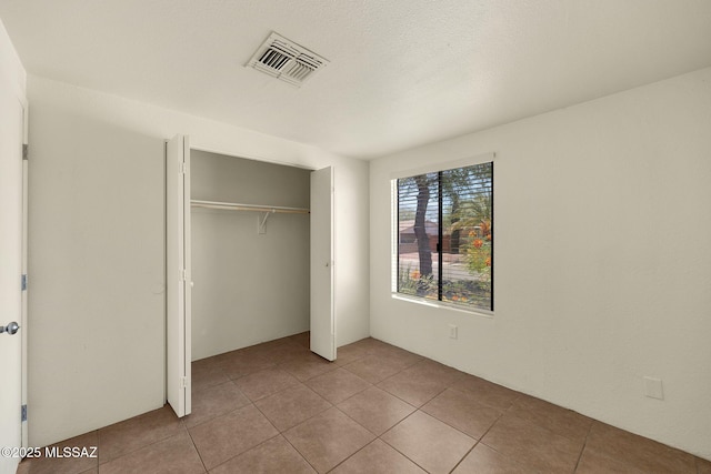 2520 W Vereda De Las Flores, Tucson, AZ 85746 - unfurnished bedroom with tile patterned flooring and a closet