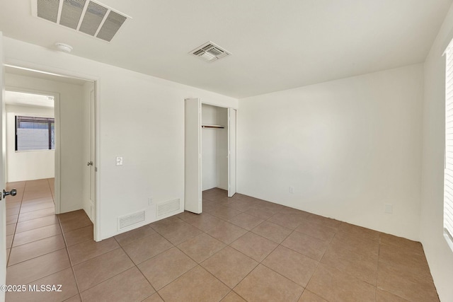 2520 W Vereda De Las Flores, Tucson, AZ 85746 - unfurnished bedroom featuring light tile patterned floors, a closet, and multiple windows