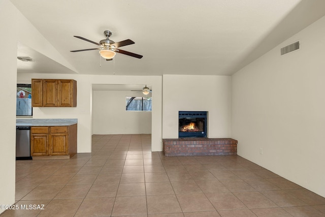 2520 W Vereda De Las Flores, Tucson, AZ 85746 - unfurnished living room featuring ceiling fan, a fireplace, light tile patterned floors, and lofted ceiling