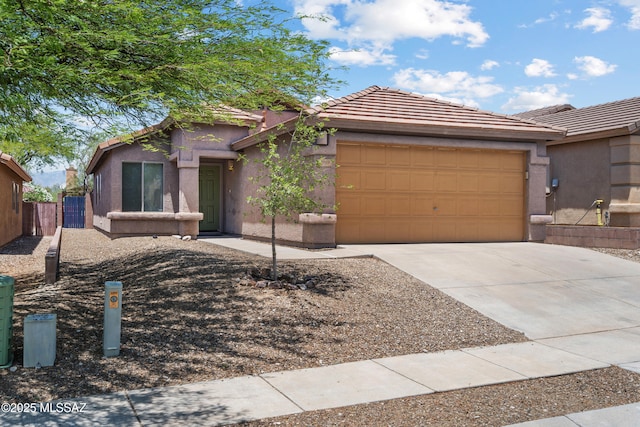 9969 E Apache Rain Dr, Tucson, AZ 85748 - view of front of house with an attached garage, concrete driveway, stucco siding, and a tiled roof