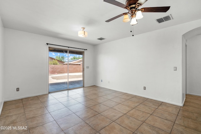 9969 E Apache Rain Dr, Tucson, AZ 85748 - tiled empty room with arched walkways and a ceiling fan