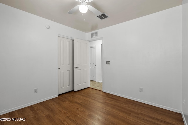 9969 E Apache Rain Dr, Tucson, AZ 85748 - unfurnished bedroom featuring wood finished floors, a closet, and a ceiling fan