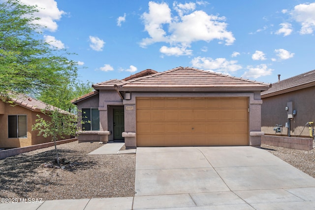 9969 E Apache Rain Dr, Tucson, AZ 85748 - view of front of house with driveway, an attached garage, a tile roof, and stucco siding
