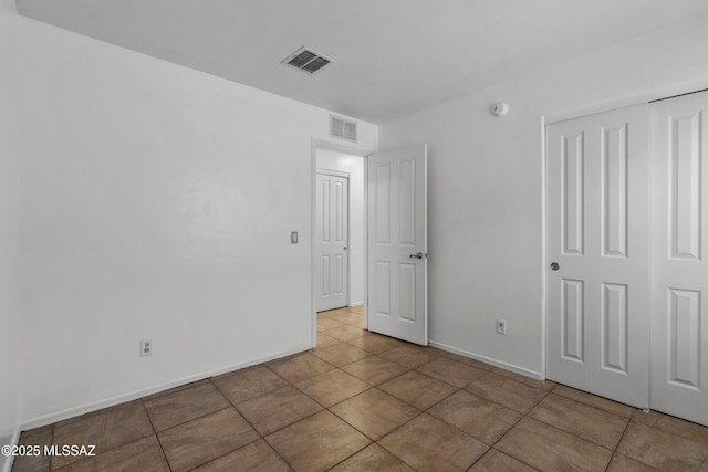 9969 E Apache Rain Dr, Tucson, AZ 85748 - unfurnished bedroom featuring a closet and tile patterned flooring