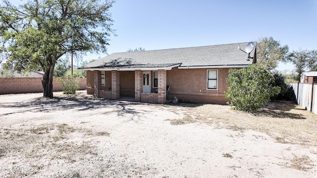 1094 N Pomerene Rd, Benson, AZ 85602 - rear view of house featuring a fenced backyard, covered porch, roof with shingles, and stucco siding