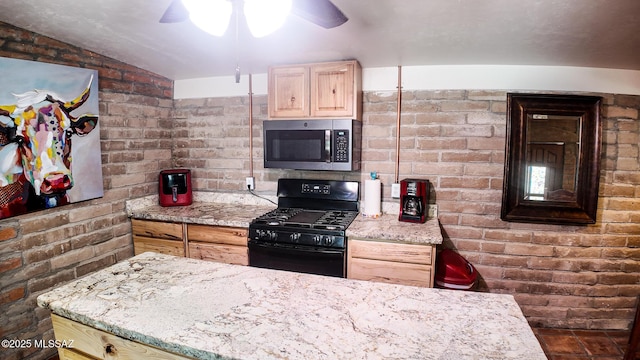 1094 N Pomerene Rd, Benson, AZ 85602 - kitchen with stainless steel microwave, gas stove, light brown cabinets, ceiling fan, and light stone countertops