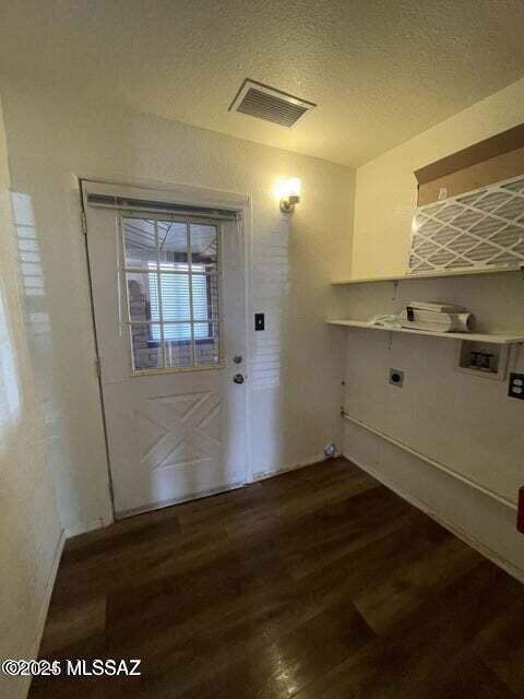1094 N Pomerene Rd, Benson, AZ 85602 - washroom featuring washer hookup, hookup for an electric dryer, dark wood-style floors, a textured ceiling, and baseboards