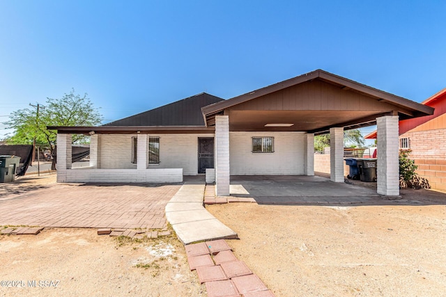 201 W Macarthur St, Tucson, AZ 85714 - view of front facade featuring brick siding and an attached carport