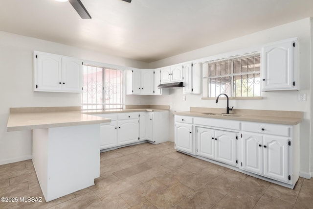 201 W Macarthur St, Tucson, AZ 85714 - kitchen featuring white cabinetry, plenty of natural light, and under cabinet range hood