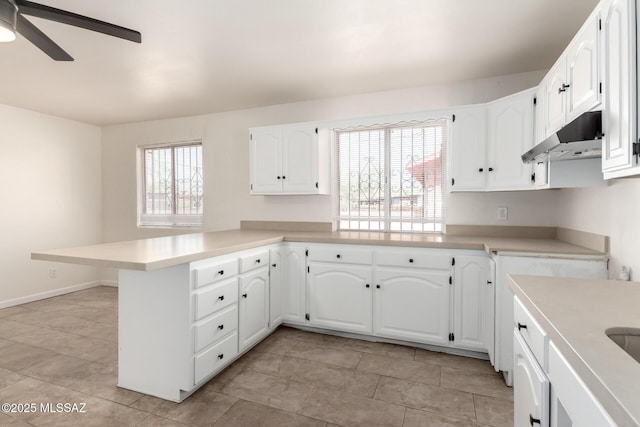 201 W Macarthur St, Tucson, AZ 85714 - kitchen with under cabinet range hood, a peninsula, white cabinetry, light countertops, and ceiling fan