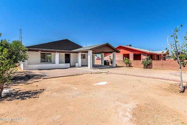 201 W Macarthur St, Tucson, AZ 85714 - back of property with a carport, brick siding, and concrete driveway