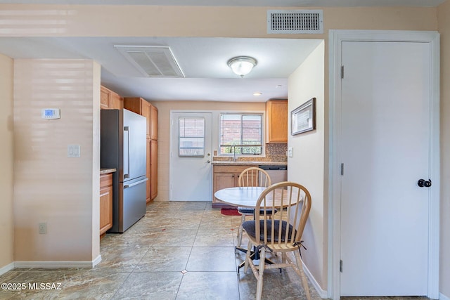 503 S Paseo Lobo Unit A, Green Valley, AZ 85614 - kitchen featuring appliances with stainless steel finishes, a sink, baseboards, tasteful backsplash, and light countertops