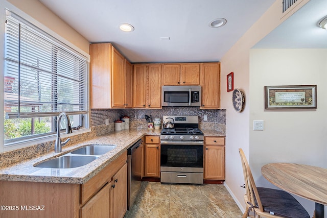503 S Paseo Lobo Unit A, Green Valley, AZ 85614 - kitchen featuring appliances with stainless steel finishes, a sink, decorative backsplash, light stone counters, and recessed lighting