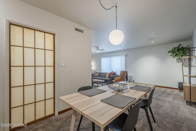 3940 E Timrod St Unit 226, Tucson, AZ 85711 - carpeted dining room featuring baseboards