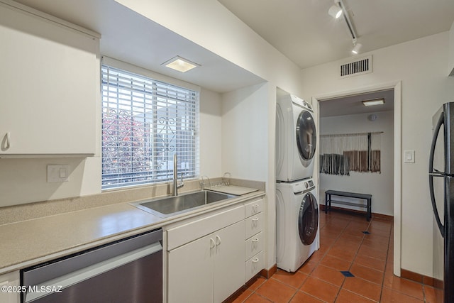 3940 E Timrod St Unit 226, Tucson, AZ 85711 - kitchen with dishwasher, stacked washer / dryer, freestanding refrigerator, a sink, and track lighting