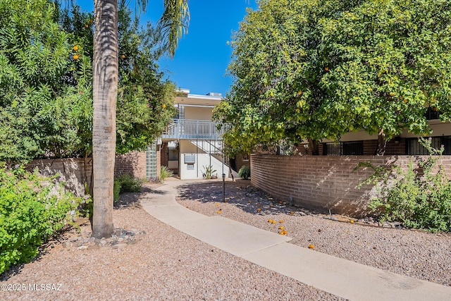 3940 E Timrod St Unit 226, Tucson, AZ 85711 - obstructed view of property featuring stairway and brick siding