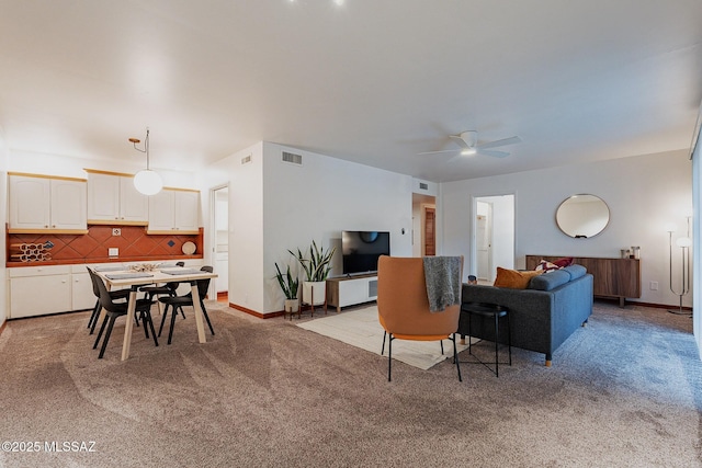 3940 E Timrod St Unit 226, Tucson, AZ 85711 - living room with light colored carpet, ceiling fan, and baseboards