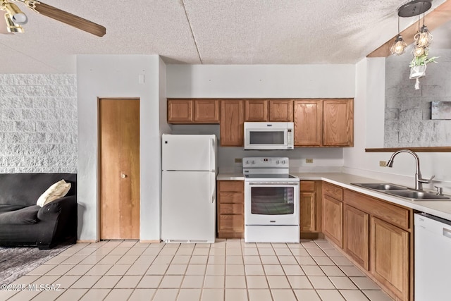 7777 E Golf Links Rd Unit 2105, Tucson, AZ 85730 - kitchen featuring white appliances, a textured ceiling, light countertops, brown cabinets, and light tile patterned floors
