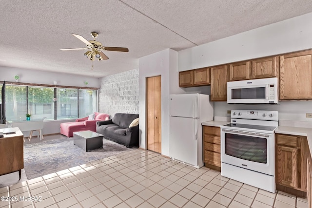 7777 E Golf Links Rd Unit 2105, Tucson, AZ 85730 - kitchen featuring white appliances, brown cabinetry, a textured ceiling, ceiling fan, and light countertops
