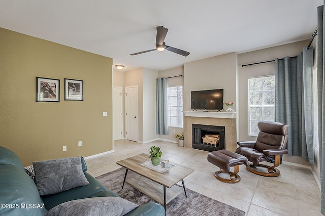1500 E Pusch Wilderness Dr Unit 15205, Oro Valley, AZ 85737 - living room featuring light tile patterned floors, a ceiling fan, and a tiled fireplace