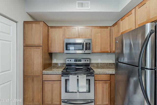 1500 E Pusch Wilderness Dr Unit 15205, Oro Valley, AZ 85737 - kitchen with appliances with stainless steel finishes and tile countertops