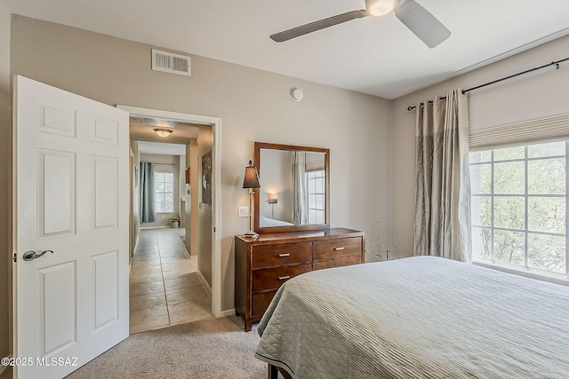 1500 E Pusch Wilderness Dr Unit 15205, Oro Valley, AZ 85737 - bedroom with light colored carpet and a ceiling fan