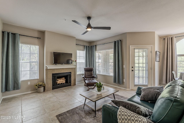 1500 E Pusch Wilderness Dr Unit 15205, Oro Valley, AZ 85737 - tiled living room featuring a ceiling fan, plenty of natural light, and a tile fireplace