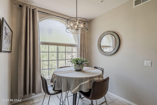 1500 E Pusch Wilderness Dr Unit 15205, Oro Valley, AZ 85737 - dining room featuring a chandelier and light tile patterned floors