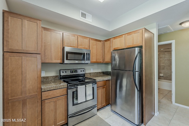 1500 E Pusch Wilderness Dr Unit 15205, Oro Valley, AZ 85737 - kitchen featuring stainless steel appliances, light tile patterned floors, tile counters, and light brown cabinets