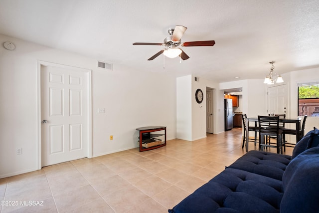 7255 E Snyder Rd Unit 9103, Tucson, AZ 85750 - living area featuring ceiling fan, light tile patterned floors, and a chandelier