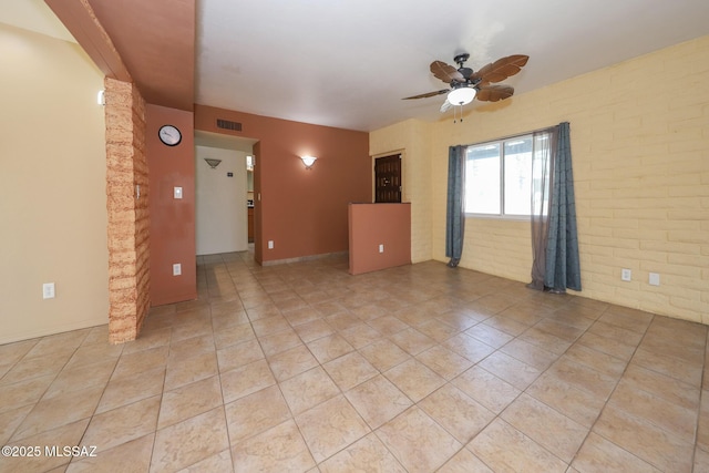 1641 S San Carla, Green Valley, AZ 85614 - spare room with a ceiling fan, light tile patterned floors, and brick wall