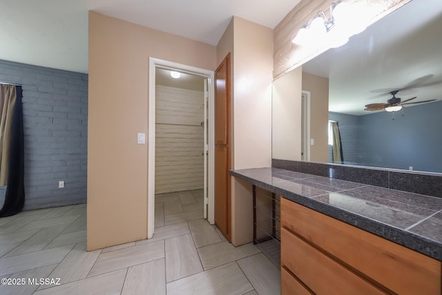 1641 S San Carla, Green Valley, AZ 85614 - bathroom with ceiling fan, vanity, and brick wall