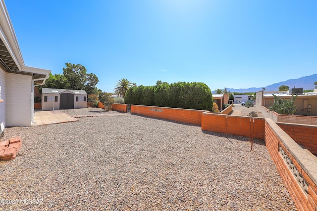 1641 S San Carla, Green Valley, AZ 85614 - fenced backyard featuring a storage unit and a mountain view