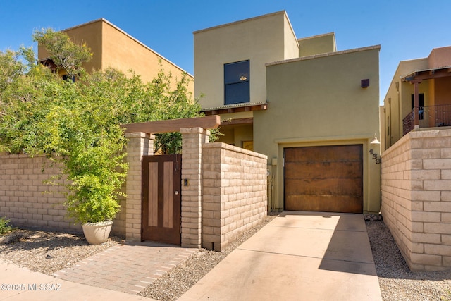 139 E Castlefield Cir, Tucson, AZ 85704 - view of front of property with an attached garage, a gate, stucco siding, and concrete driveway