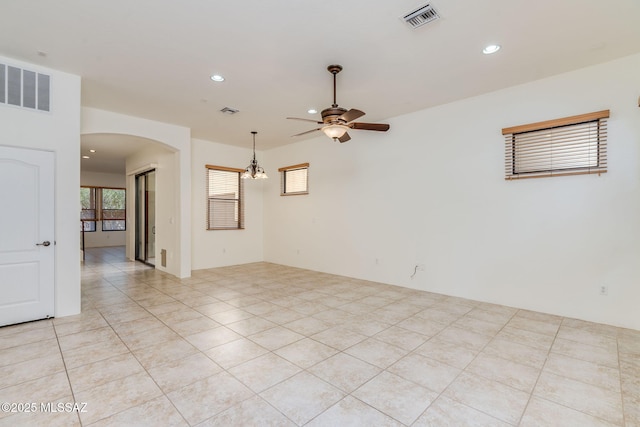 139 E Castlefield Cir, Tucson, AZ 85704 - spare room with arched walkways, ceiling fan, recessed lighting, and light tile patterned floors