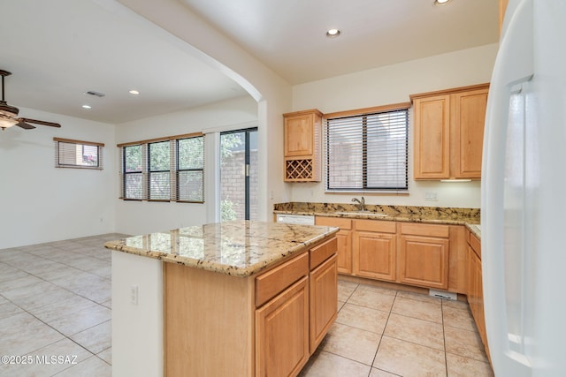 139 E Castlefield Cir, Tucson, AZ 85704 - kitchen featuring freestanding refrigerator, a kitchen island, light tile patterned flooring, recessed lighting, and a ceiling fan