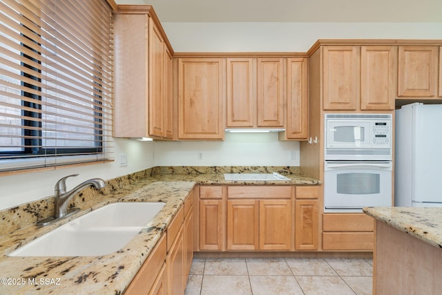 139 E Castlefield Cir, Tucson, AZ 85704 - kitchen featuring white appliances, light tile patterned floors, light brown cabinets, and light stone countertops