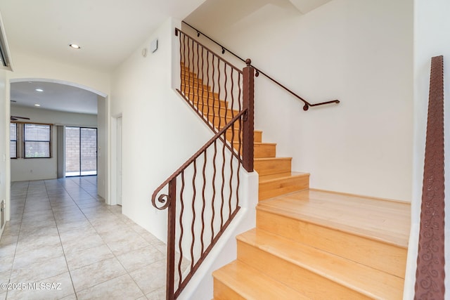 139 E Castlefield Cir, Tucson, AZ 85704 - staircase with arched walkways, tile patterned floors, and recessed lighting