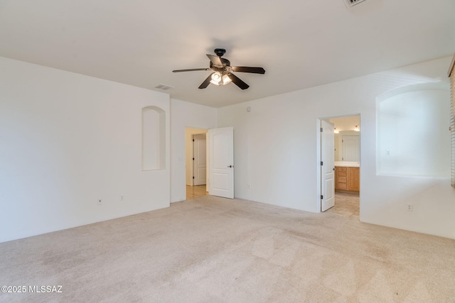 139 E Castlefield Cir, Tucson, AZ 85704 - unfurnished bedroom featuring light carpet, ensuite bath, and a ceiling fan