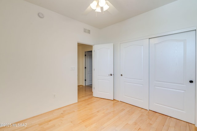139 E Castlefield Cir, Tucson, AZ 85704 - unfurnished bedroom with light wood-style flooring, a closet, and a ceiling fan
