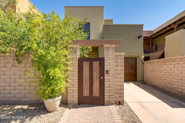 139 E Castlefield Cir, Tucson, AZ 85704 - property entrance with a gate and stucco siding